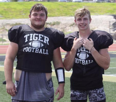 JUSTIN WRIGHT (left), shown after a preseason high school football camp with teammate Dawson Claypole, is taking his gridiron skills to Baker University, a private school in Baldwin City, Kan. MIRANDA JAMISON | Staff