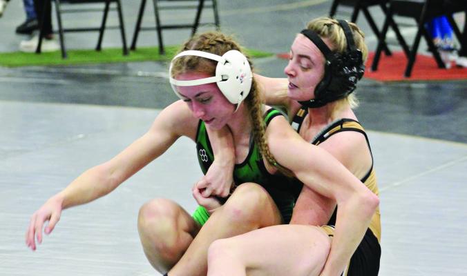 JUNIOR ALYSSA BETTS, right, secures a cradle hold en route to winning a match by pin as part of a hectic week of girls wrestling at Excelsior Springs High School. DUSTIN DANNER | Staff