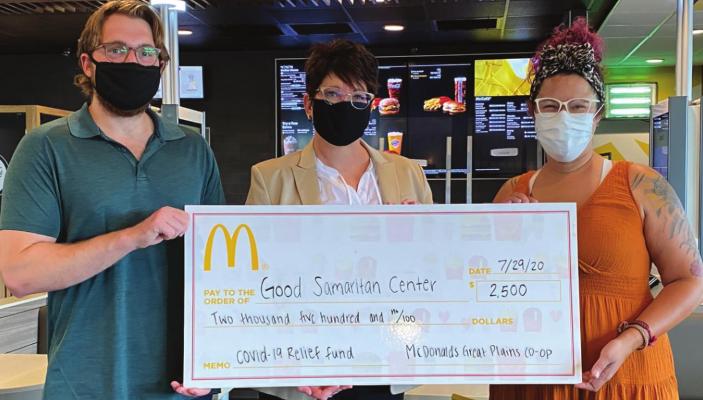 THE NOVELTY CHECK presentation is made, from left, by Ethan and Lisa Essig of Essig and Associates to Sara Noblet of the Good Samaritan Center of Excelsior Springs.