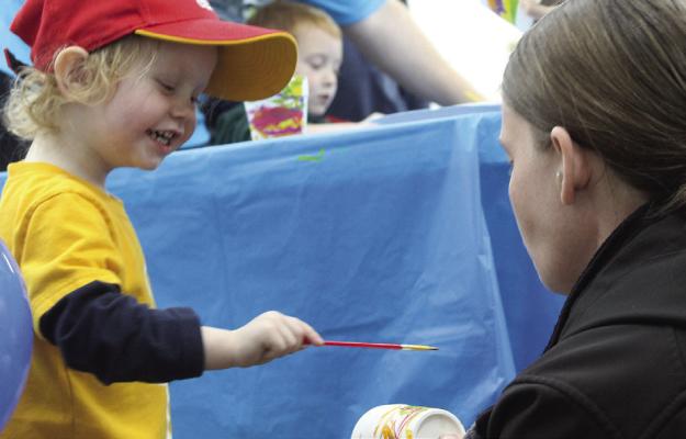 MIRANDA JAMISON | Staff JAXSYN BERRY-LEWIS (left) makes art with the help of his mother.