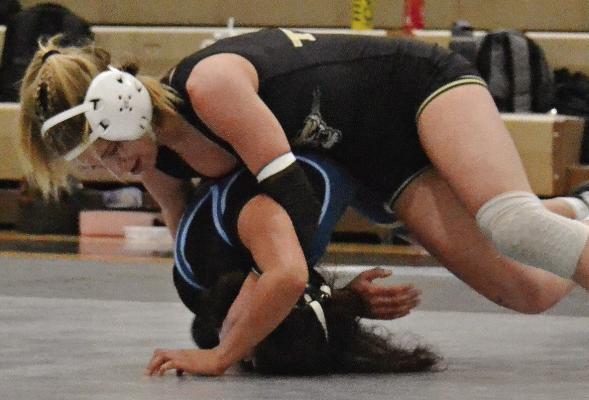 LILLAH SHUE, an Exelsior Springs junior, works from the top position to turn her opponent during a varsity girls wrestling dual. DUSTIN DANNER | Staff