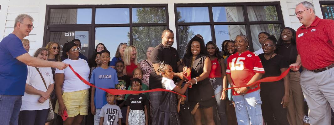 SKIN EQUITY DERMATOLOGY &amp; AESTHETICS owner Vinesha Byers (center), husband DeAundre Byers and their children, Ala and Duece, join community members in cutting the ribbon to celebrate the opening of the new Excelsior Springs clinic. MIRANDA JAMISON | Staff