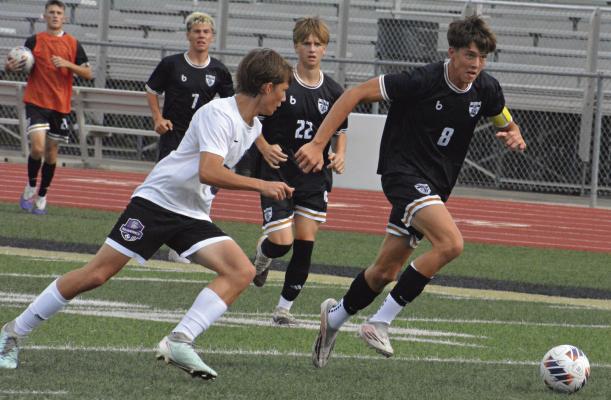 TYLER WARTNER (right) pursues the ball during Excelsior Springs’ tournament meeting with Kearney. The Tigers, who defeated their Missouri Highway 92 rivals, were scheduled to play Kearney again this week in a stand-alone game. Soccer coverage continues on page 6. SHAWN RONEY | Staff