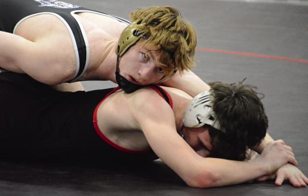 EXCELSIOR SPRINGS SENIOR Cooper Collins (top) maintains control during his title bout at the Richmond Invitational. Varsity boys wrestling coverage continues on page 6. SHAWN RONEY | Staff