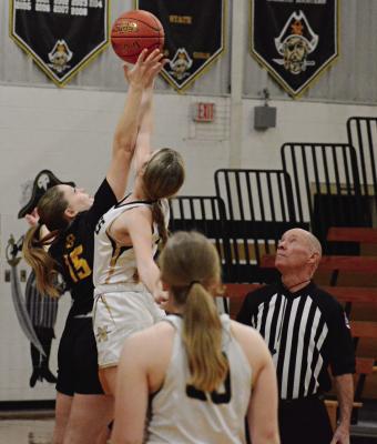 PLAYING IN what ends up being her last high school basketball game, Orrick senior Natasha Hicks (No. 15) goes up for the tipoff to start the Bearcats’ Class 1 District 13 meeting with Noborne Monday at Norborne. SHAWN RONEY | Staff