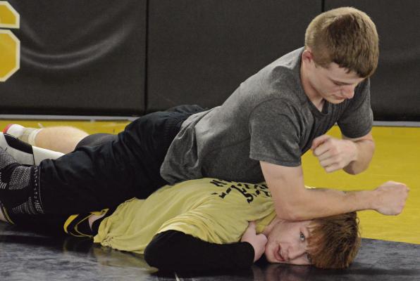 ASSISTANT COACH Landen Davis (top) practices with Cooper Collins. Collins, a senior, is part of a corps of experienced Excelsior Springs varsity boys wrestlers. SHAWN RONEY | Staff