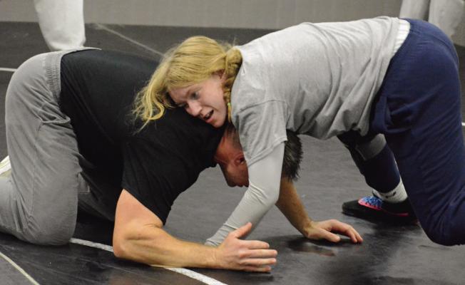 ASSISTANT COACH Brock Nessa (left) works with Haylee Ray on technique as the Excelsior Springs High School girls prep for their wrestling campaign. SHAWN RONEY | Staff