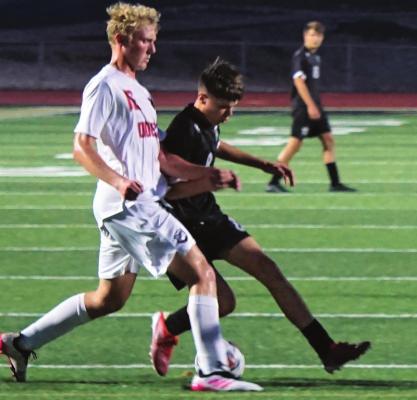 MASON WARTNER, in black, fights for possesion during Excelsior Springs’ Oct. 12 meeting with visiting Odessa. DUSTIN DANNER | Staff