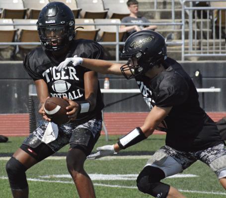 GREAT GEAR makes it easy to capture images like this one of Excelsior Springs quarterback Marquez McCant (left) handing off to Gaige Carr. SHAWN RONEY | Staff