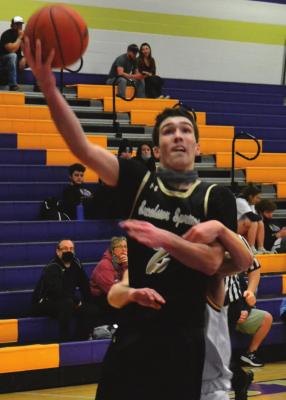 JUNIOR GANNON WILLIS puts in a layup while getting fouled in action last week at Pleasant Hill. DUSTIN DANNER | Staff