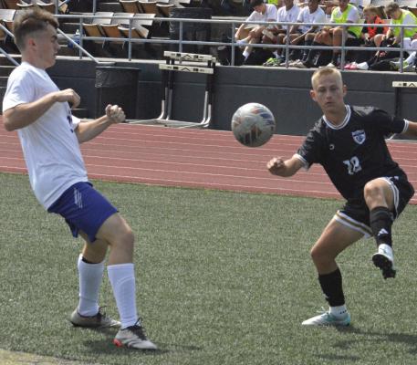 NICK COLVIN (right) volleys the ball for the Tigers during their jamboree scrimmage with St. Paul Lutheran of Concordia. Excelsior Springs also scrimmaged with Kearney and Grain Valley.