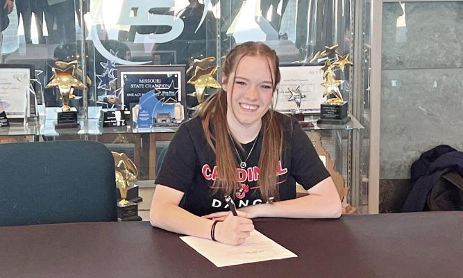 KELSEY COLEMAN signs her letter of intent to be part of the dance team at William Jewell College in Liberty. DUSTIN DANNER | Staff