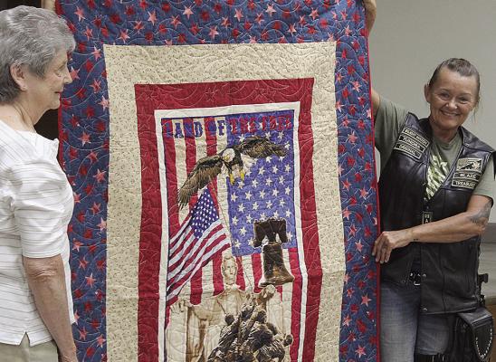 BOBBI DUNLAP (right) receives a Quilt of Valor honoring her U.S. Army service from 1988 to 1997, including her work in logistics and supply. MIRANDA JAMISON | Staff