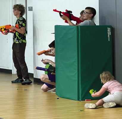 ESPRCC | Submitted LOCAL KIDS take cover and aim their Nerf guns during an event to celebrate Parks and Recreation Month.