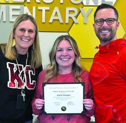 KAYLA NIBARGER (center) is presented with the Excelsior Springs School District’s Certified Employee of the Month recognition for her hard work and dedication to Cornerstone Elementary. Submitted