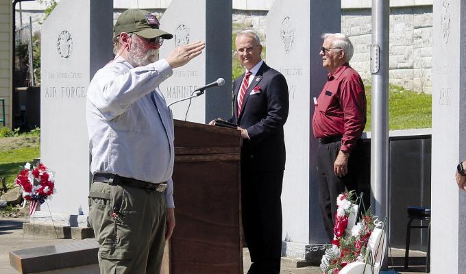 JOE ARTHUR salutes beside the Coast Guard monument after presenting a wreath during the Memorial Day observance. MIRANDA JAMISON | Staff