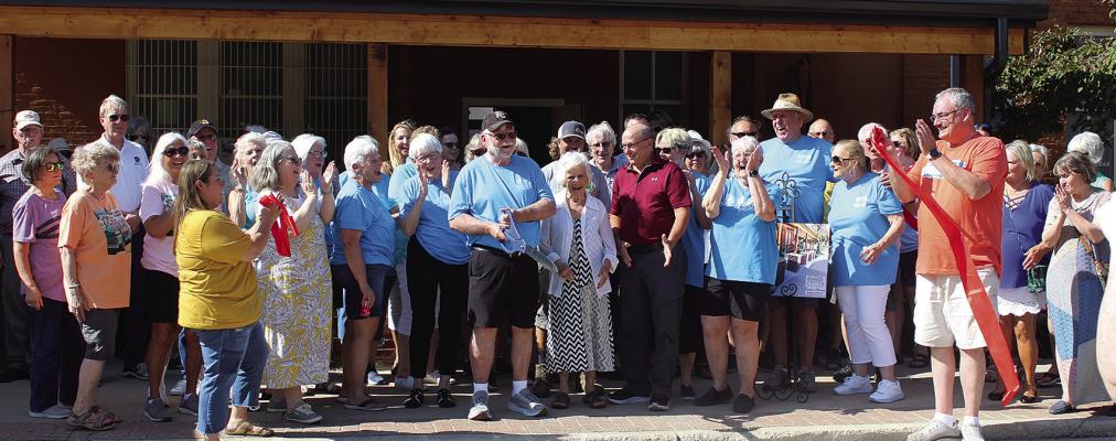 GUESTS GATHER FOR a ribbon cutting and grand opening of a new outdoor patio at the Excelsior Springs Museum and Archives. MIRANDA JAMISON | Staff