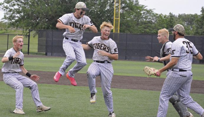 MEMBERS OF the Excelsior Springs varsity baseball squad rush to the interior of the infield to form a jubilation dogpile after the Tigers’ Class 4 state quarterfinal win over St. Michael the Archangel. With the victory, the Tigers secured another trip to the state semis for assistant coach Simon Holst, the son of former Excelsior Springs skipper Aaron Holst. SHAWN RONEY | Staff