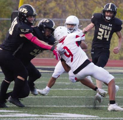 THE JV TIGERS tackle a Park Hill player after a punt.