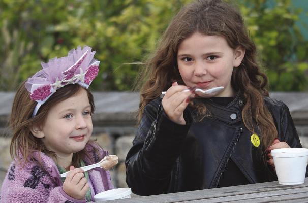MIRANDA JAMISON | Staff MADILYN MARTIN (left) and Scarlett McKinney listen to live music while taking an ice cream break.
