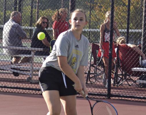 REBECCA McDADE, an Excelsior Springs junior, looks to hit a two-fisted backhand shot Oct. 4 against Carrollton in district play at Excelsior Springs. DUSTIN DANNER | Staff