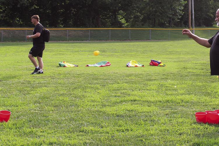 ORION BRYAN (from left), Rick Willis and Ashley Bryan try their luck at one of the evening’s lawn games.