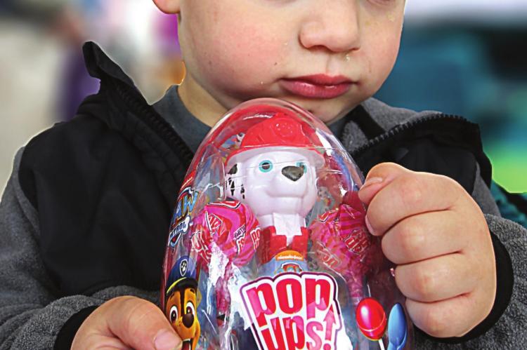 DO NOT TOUCH. Layton Farris, 2, is protective of his Pop Ups, a container of lollipops he claims as a prize after the hunt.