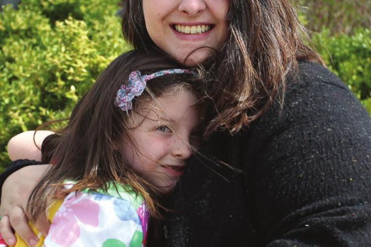 WHILE WAITING for the hunt to begin on a cool spring day, Emerald O’Brien, 6, hugs her mother, Rebekah O’Brien.