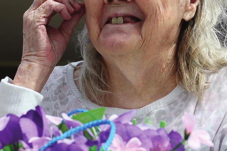 A RESIDENT at Excelsior Springs Nursing and Rehab, Betty Cureton, 87, smiles while watching children prepare to hunt eggs.