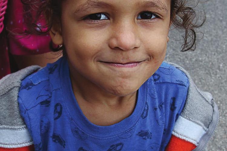 LOOK AT THESE… While holding on to two eggs and balancing a third, Marylus Bailey, 3, presents a satisfied smile.