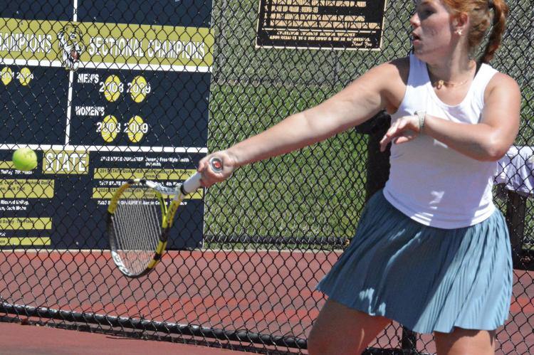 OLIVIA DEERE keeps her eyes on the ball while attempting a forehand shot during an Excelsior Springs tennis camp sessions for high schoolers. SHAWN RONEY | Staff