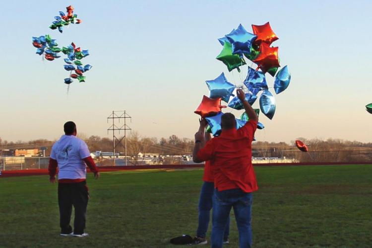 DOZENS OF BALLOONS fly from the middle of the Richmond High School football field in celebration of International Day for People with Disabilities.