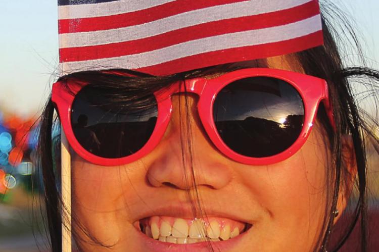 DISPLAYING patriotism, Richmond High School student Aspen Erskine attaches a flag to her shades.