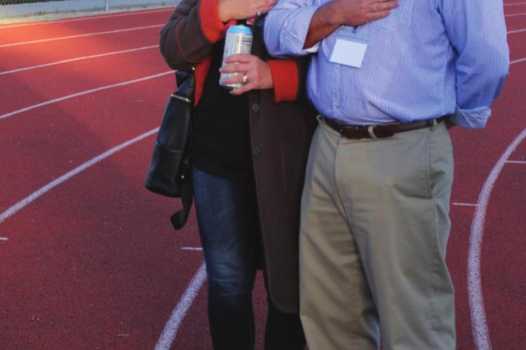 PASTOR PHIL and wife Christine Powers stand for the national anthem.
