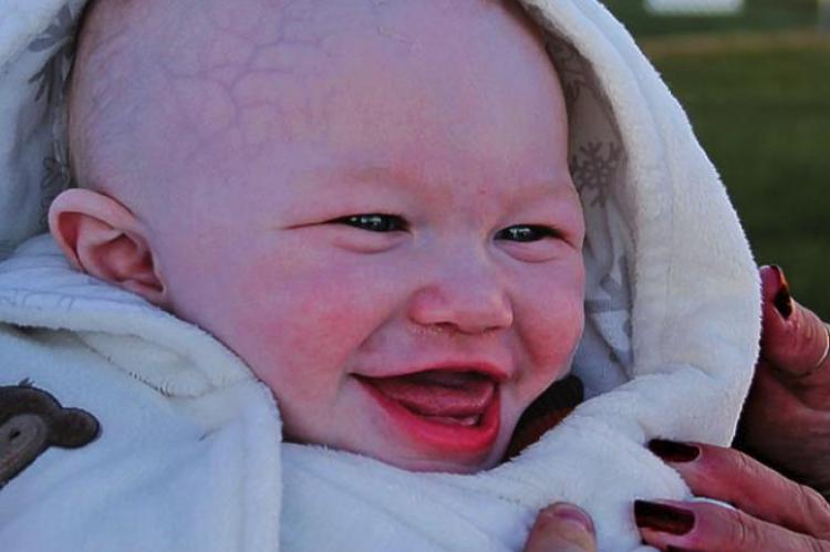 DRAWING A CROWD, Jasper Brown, 7 months, smiles for People with Disabilities Day in Ray County.