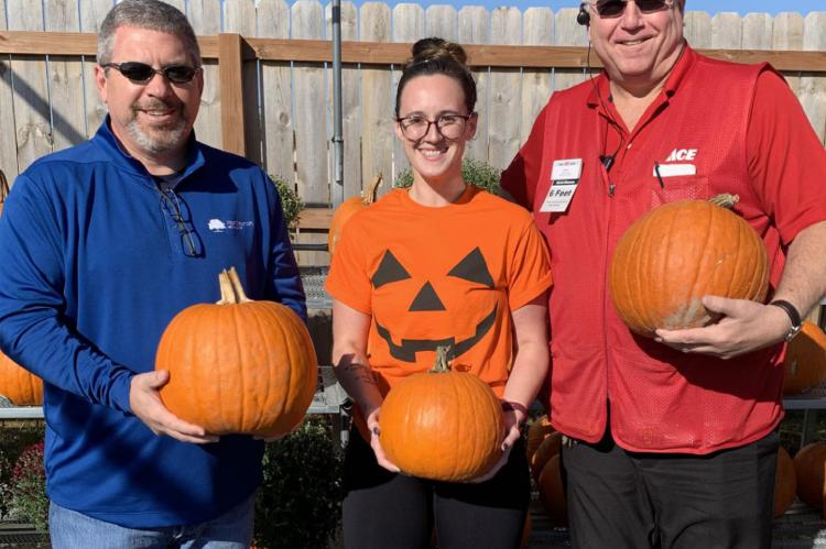 PUMPKINS READY: From left are Tray Harkins with the Gregg Williams Foundation and Flat Branch Home Loans; Cassie Kinnard, Excelsior Springs Community Center aquatics manager; and Bill Westerheide, Westlake ACE Hardware of Excelsior Springs.
