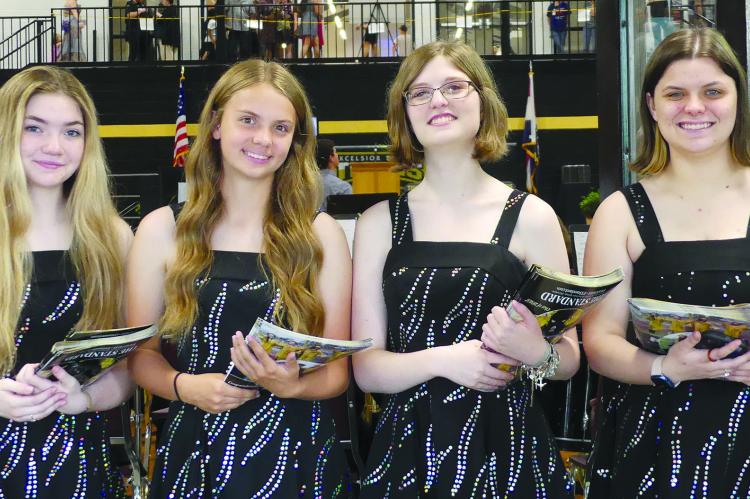 LAUREN PARK (from left), Abigail Rash, Tristen BenneT and Abagial Weaver, distributed programs to guests.