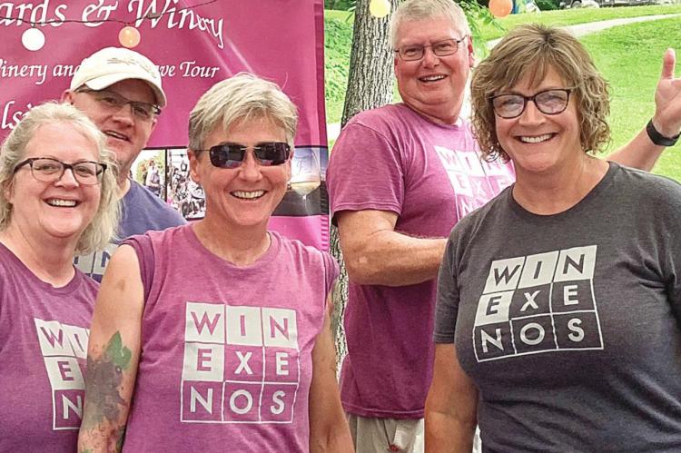 LOCAL FENCE STILE WINERY members Mike and Kelly Mann, Shawna Mull, and Tim and Janet Sabin enjoy the warm yet busy day on Lover’s Lane in downtown Excelsior Springs’ East Valley Park.