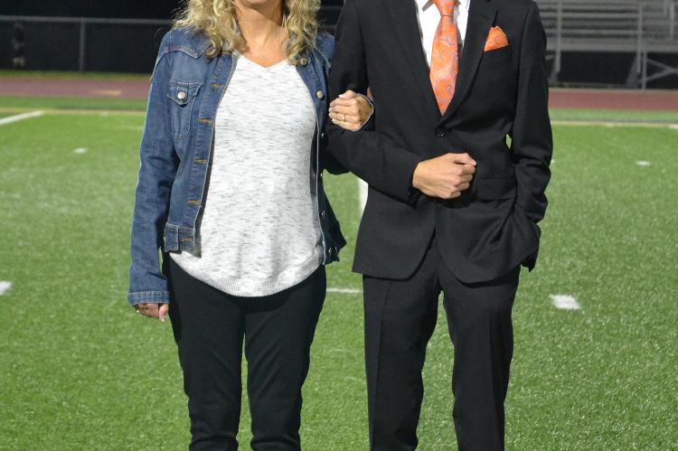 Senior king candidate Drake Clevenger is escorted by his mother Staci Clevenger. (Photo by Jae Juarez)