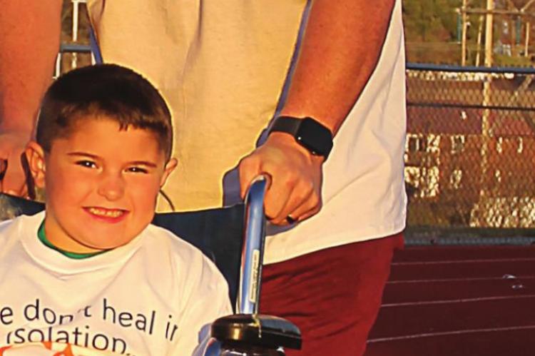 AROUND Richmond High School’s track, Anthony Rowan jogs with his son Laine, 6, who encourages him: “Go faster, Daddy. Go!” They participate in International Day for People with Disabilities. Find details on Page 10. J.C. VENTIMIGLIA | Staff