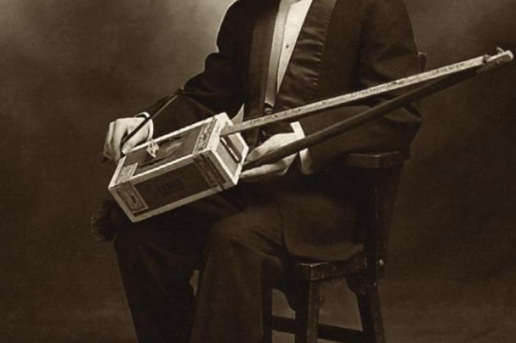 SHANE SPEAL COLLECTION | Reprinted with permission VAUDEVILLE STAR Lee Moran sits with his cigar box instruments in 1921.