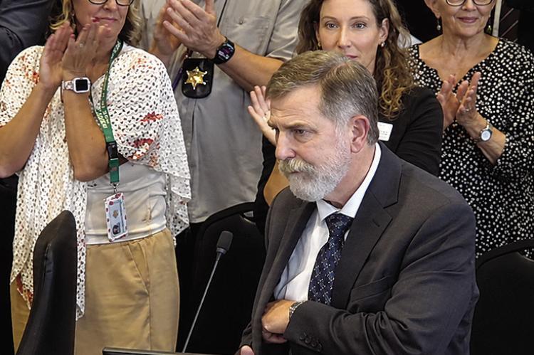 JUDGE SHANE T. ALEXANDER becomes emotional as attendees give him a standing ovation following a resolution honoring his judicial service. Submitted
