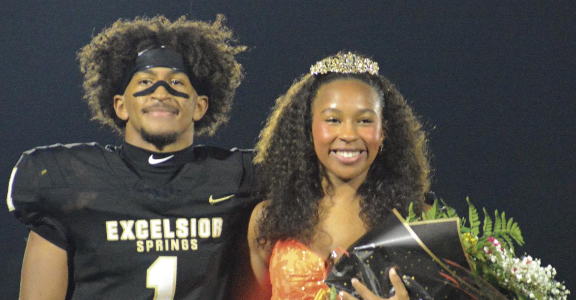 SHAWN RONEY | Staff NICK MUBANGA (left) pulls double duty during Excelsior Springs’ homecoming game with Chillicothe, escorting his sister Audra during halftime. Audra was named freshman princess, while Mubanga scored two second-half touchdowns.