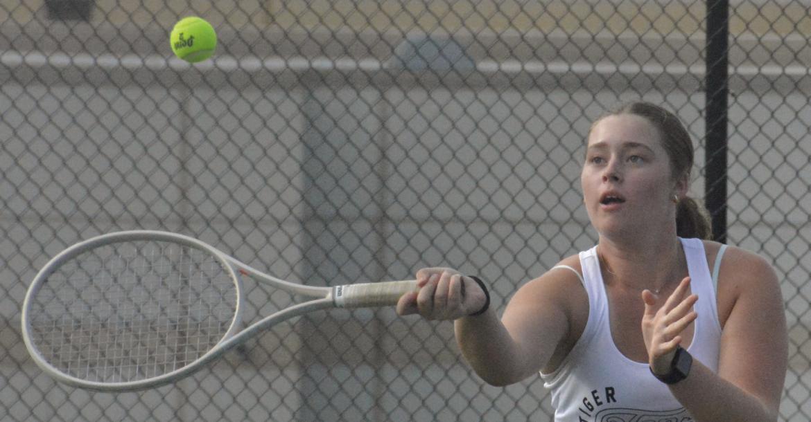 SHAWN RONEY | Staff SENIOR LANEY SMITH attempts a forehand shot near the net during Excelsior Springs’ varsity girls tennis dual with Raytown South.