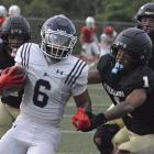 NICK MUBANGA (right) leads in pursuit of the football during the Tigers’ preseason jamboree scrimmage with Oak Park. Excelsior Springs also scrimmaged with East Buchanan. SHAWN RONEY | Staff