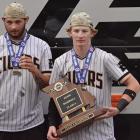 EXCELSIOR SPRINGS BASEBALL TEAMMATES Brody Querry (left) and Cooper Collins sport their Class 4 state championship medals after exiting the Tigers’ charter bus. SHAWN RONEY | Staff