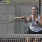 SENIOR LANEY SMITH attempts a forehand shot near the net during Excelsior Springs’ varsity girls tennis dual with Raytown South. SHAWN RONEY | Staff