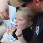 SAWYER WILSON COOLS off with shaved ice alongside his father, Billy, during Excelsior Springs’ 2026 Waterfest. MIRANDA JAMISON | Staff