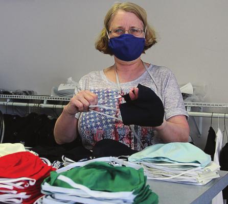 MAKING THE PILE of masks helps to keep Cindy Weir’s business, Alterations and Custom Sewing, Excelsior Springs, going during the spring and early summer. Mask sales help offset a decline in regular business. J.C. VENTIMIGLIA | The Staff