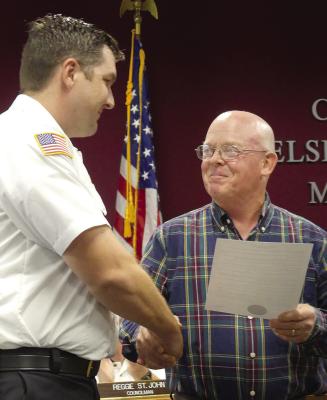 MAYOR MARK SPOHN (right) presents Assistant Fire Chief Zachary St. John (left) with a new proclamation citing Oct. 8-14, Fire Prevention Week. ELIZABETH BARNT | Staff